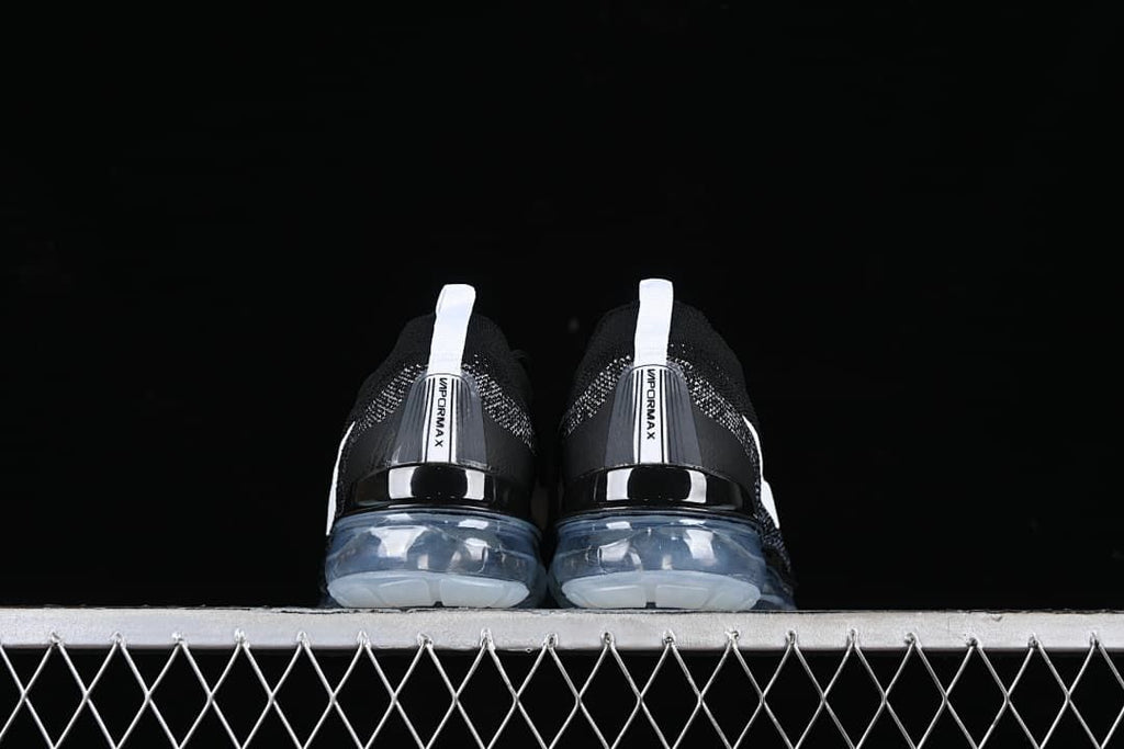 Rear view of both shoes showing heel tabs and translucent soles.