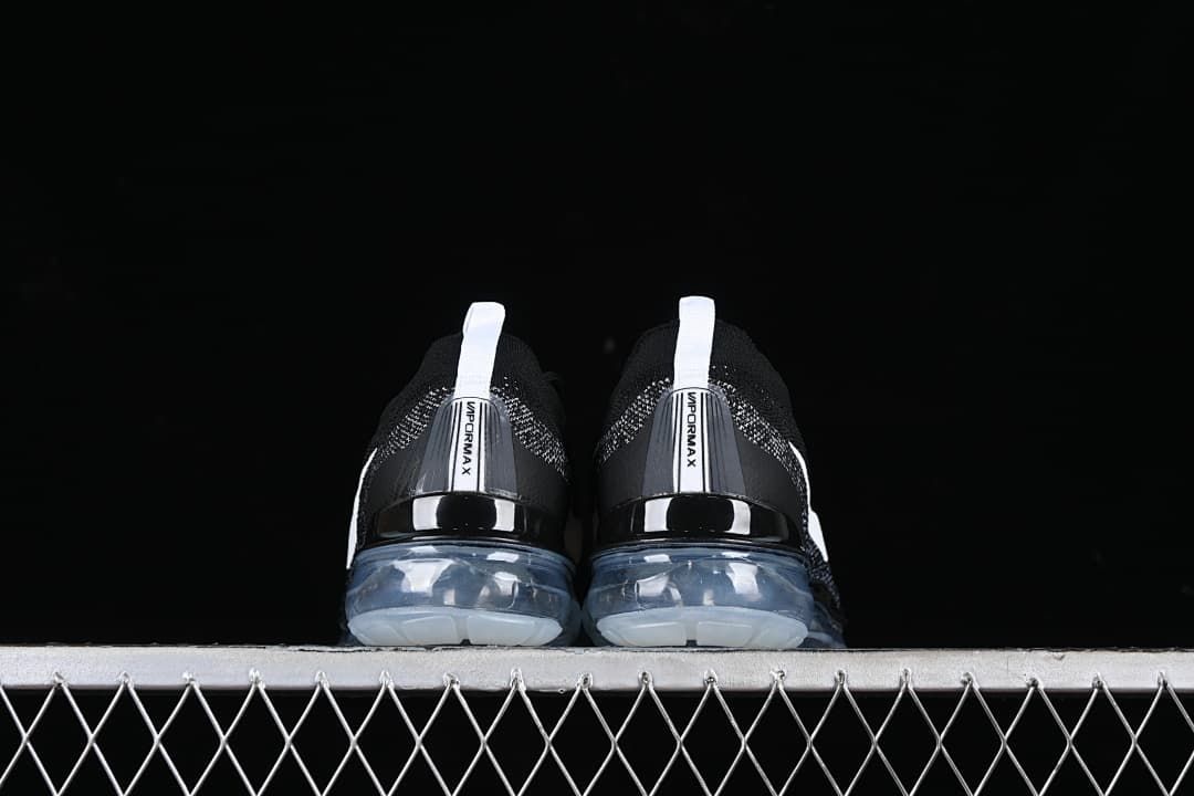 Rear view of both shoes showing heel tabs and translucent soles.