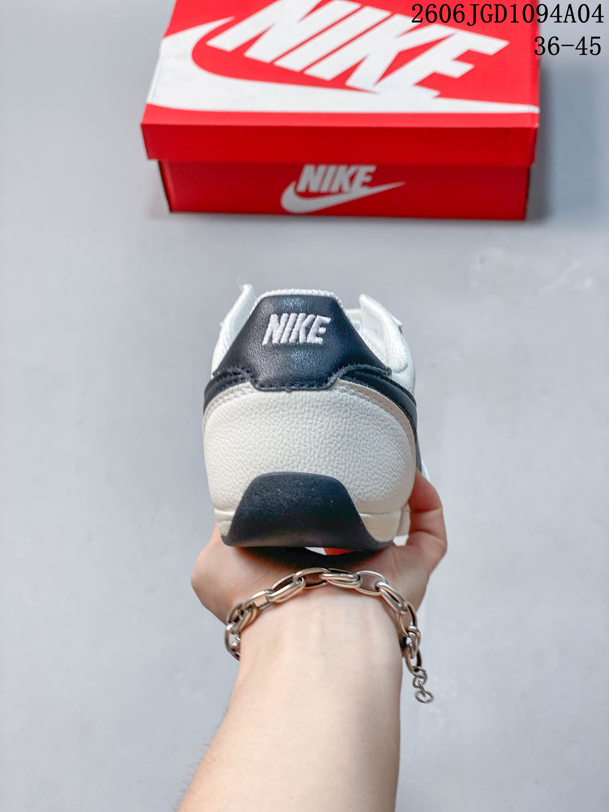Rear view of a white sneaker with a dark heel tab and Nike branding