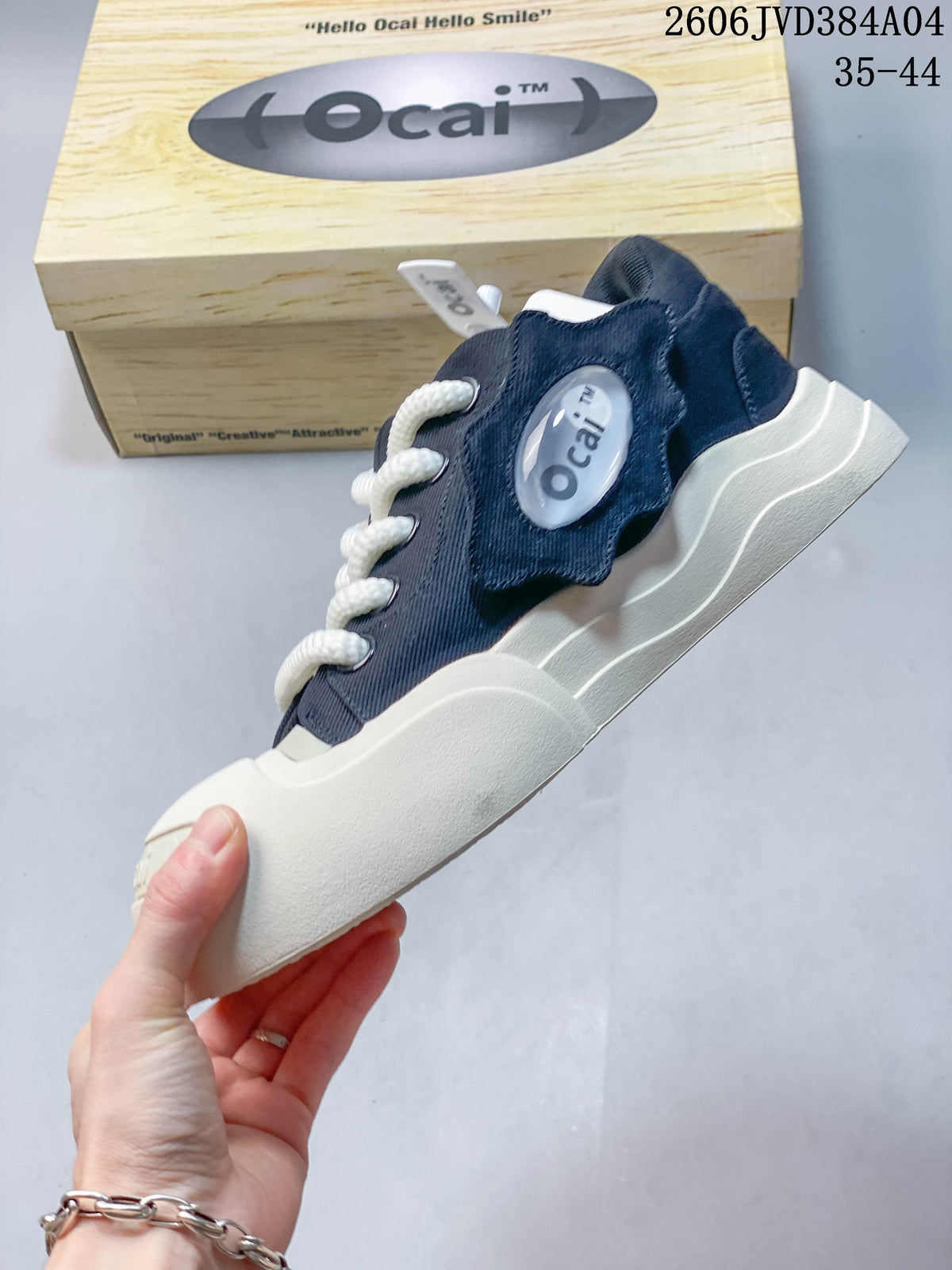 Side view of a navy Ocai sneaker with raised white sole and oval side detail