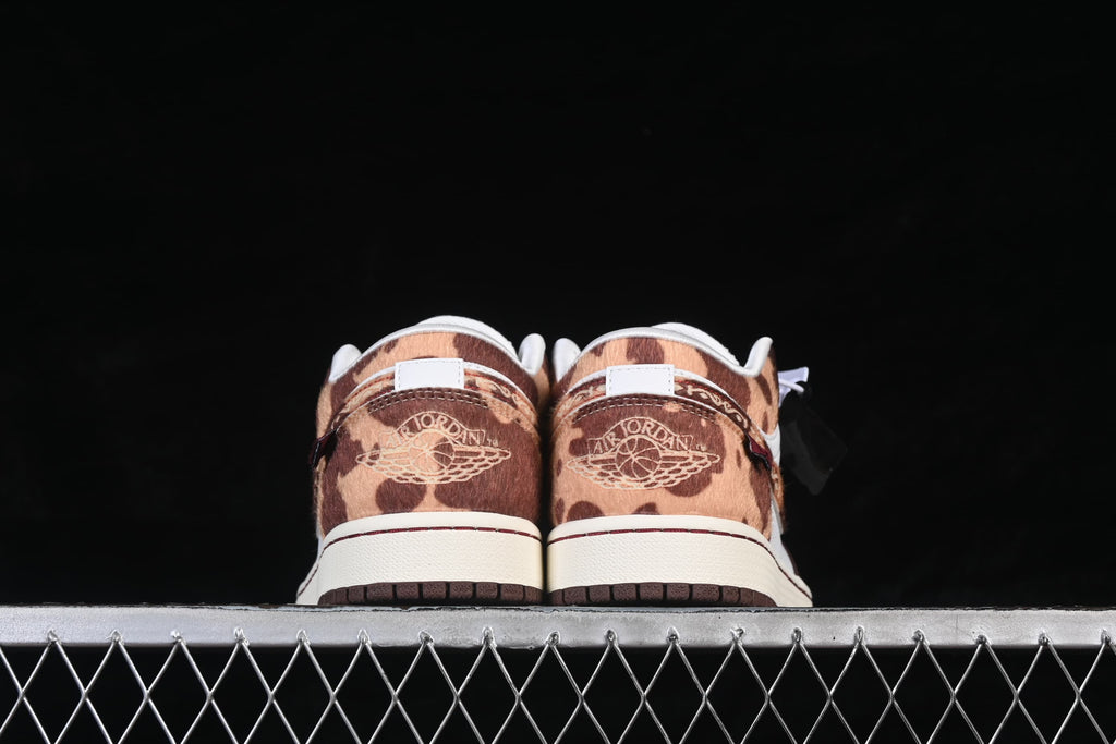 Rear view showing patterned brown heels and embroidered Jordan Wings details.