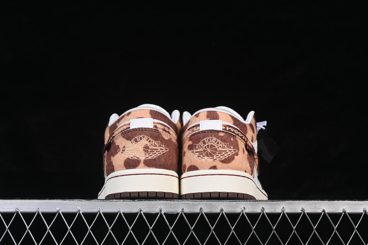 Rear view showing patterned brown heels and embroidered Jordan Wings details.