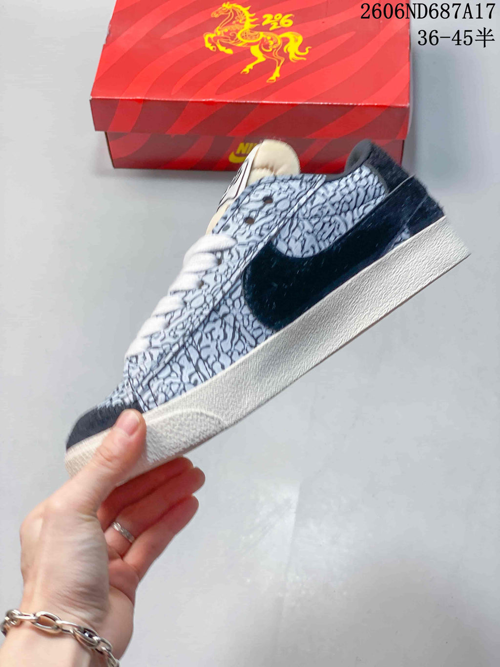 Side view of a patterned Nike Court Royale AC sneaker with a navy Swoosh