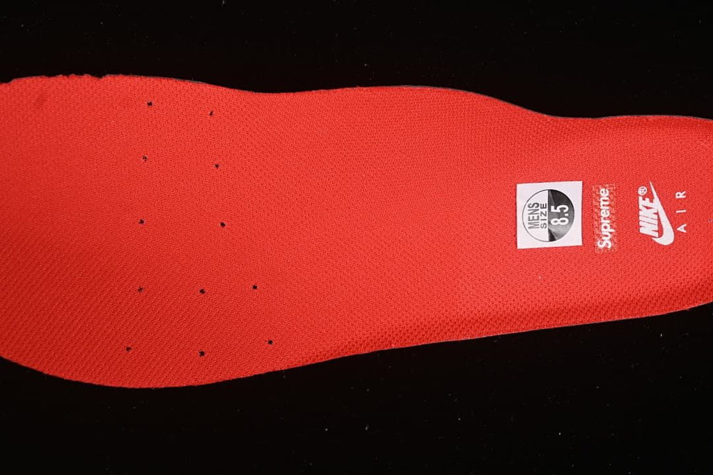 Red insole with Nike Air and Supreme branding; sample size label reads men's 8.5