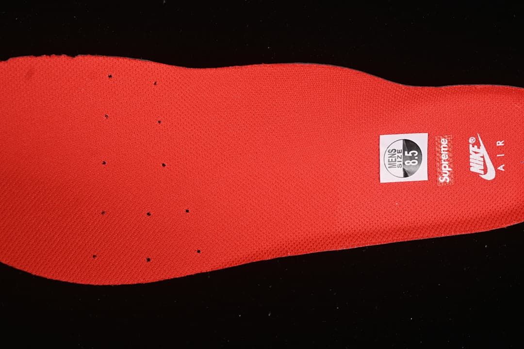Red insole with Nike Air and Supreme branding; sample size label reads men's 8.5