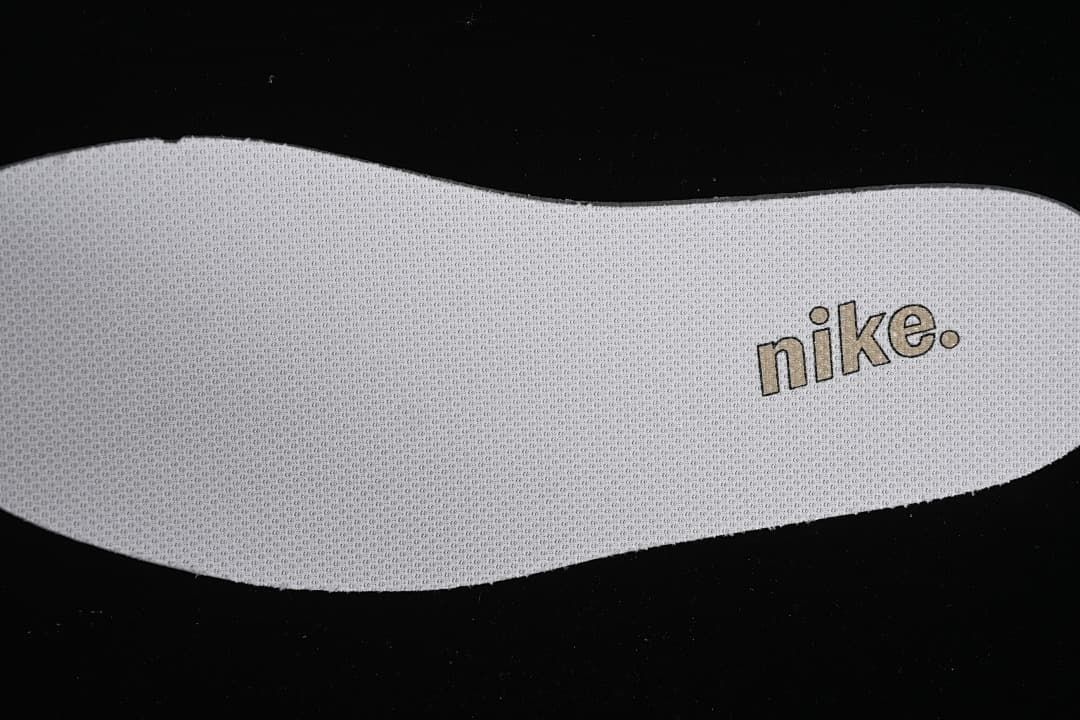 Close-up of a textured shoe insert with Nike branding.
