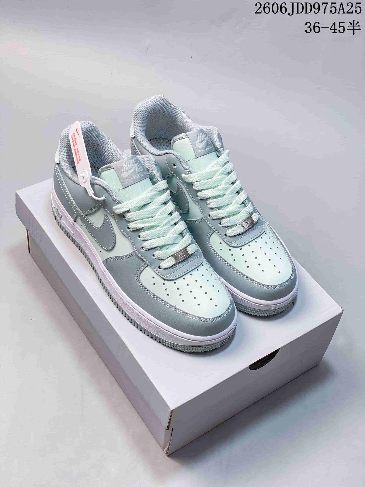Pair of light blue and white Nike Air Force 1 low-top sneakers with perforated toes.