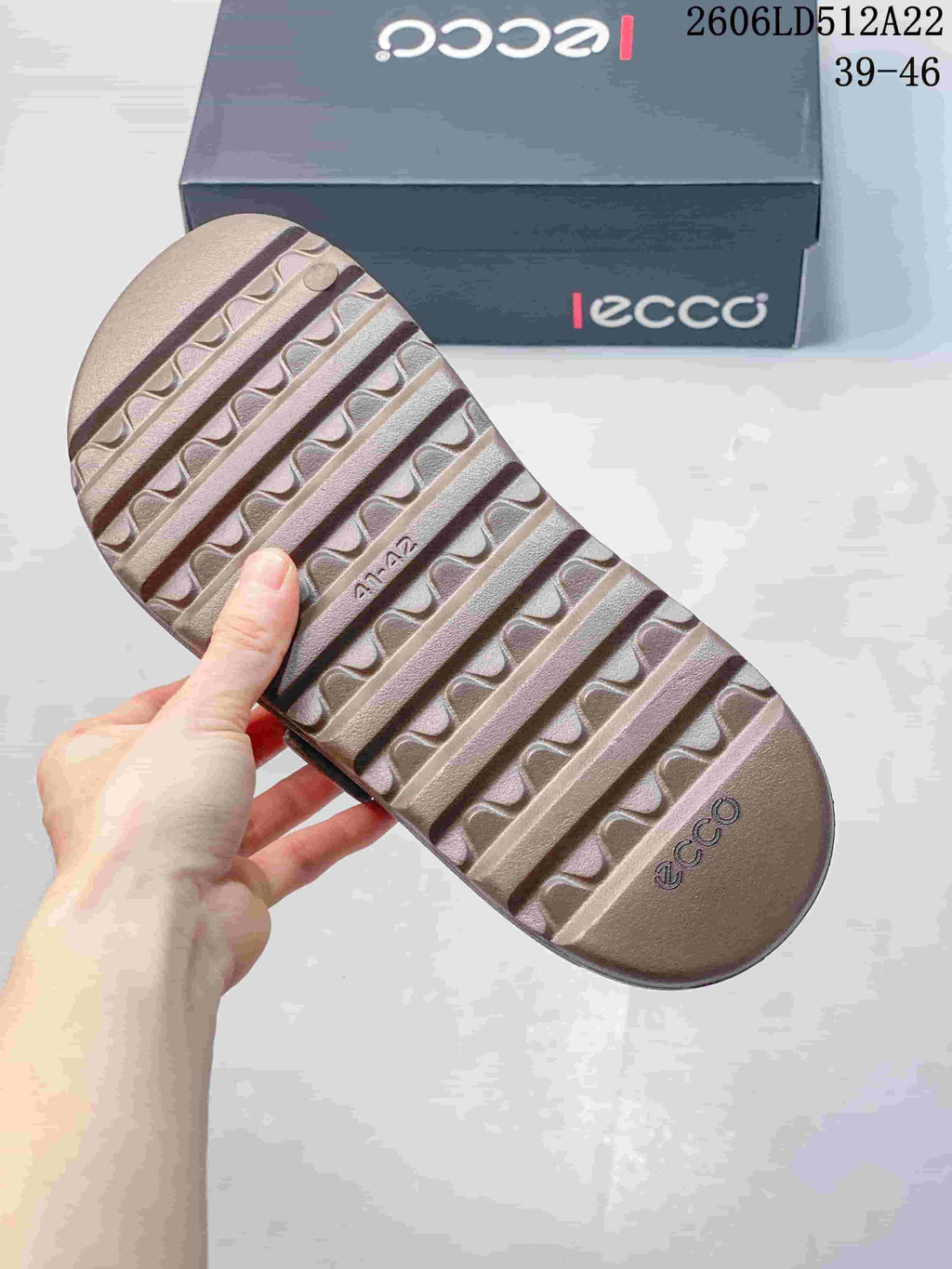 Underside of a taupe sandal showing the ridged outsole.