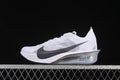 Side profile of a white Nike ZoomX Vaporfly NEXT% 4 road racing shoe with dark gray Swoosh and silver-toned midsole.