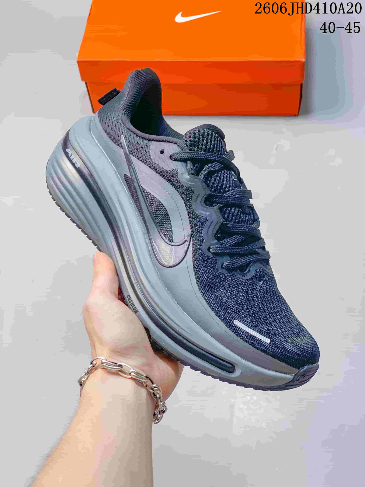 Side view of a dark gray Nike Air Zoom Winflo 12 shoe with a sculpted gray midsole.