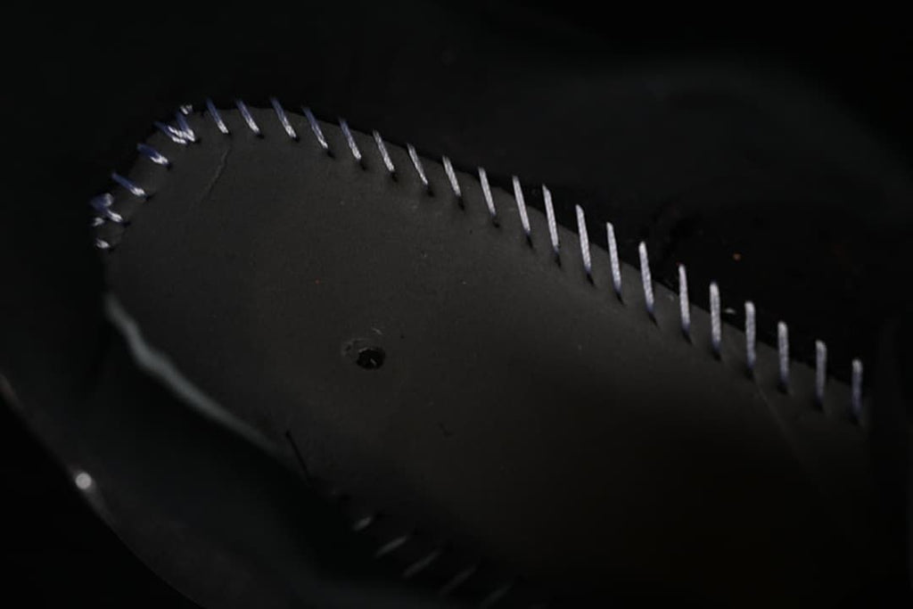 Close-up of stitching on the underside of the shoe