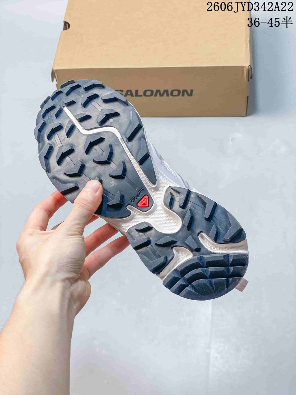 Close-up of the sneaker outsole showing its dark, lugged tread