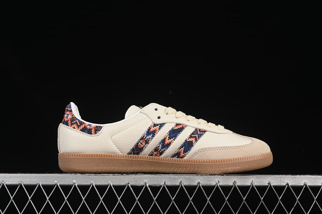 Side profile of a cream sneaker with multicolor patterned stripes and gum outsole