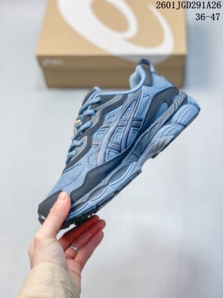 Side view showing the layered blue and grey upper, laces and sculpted sole.