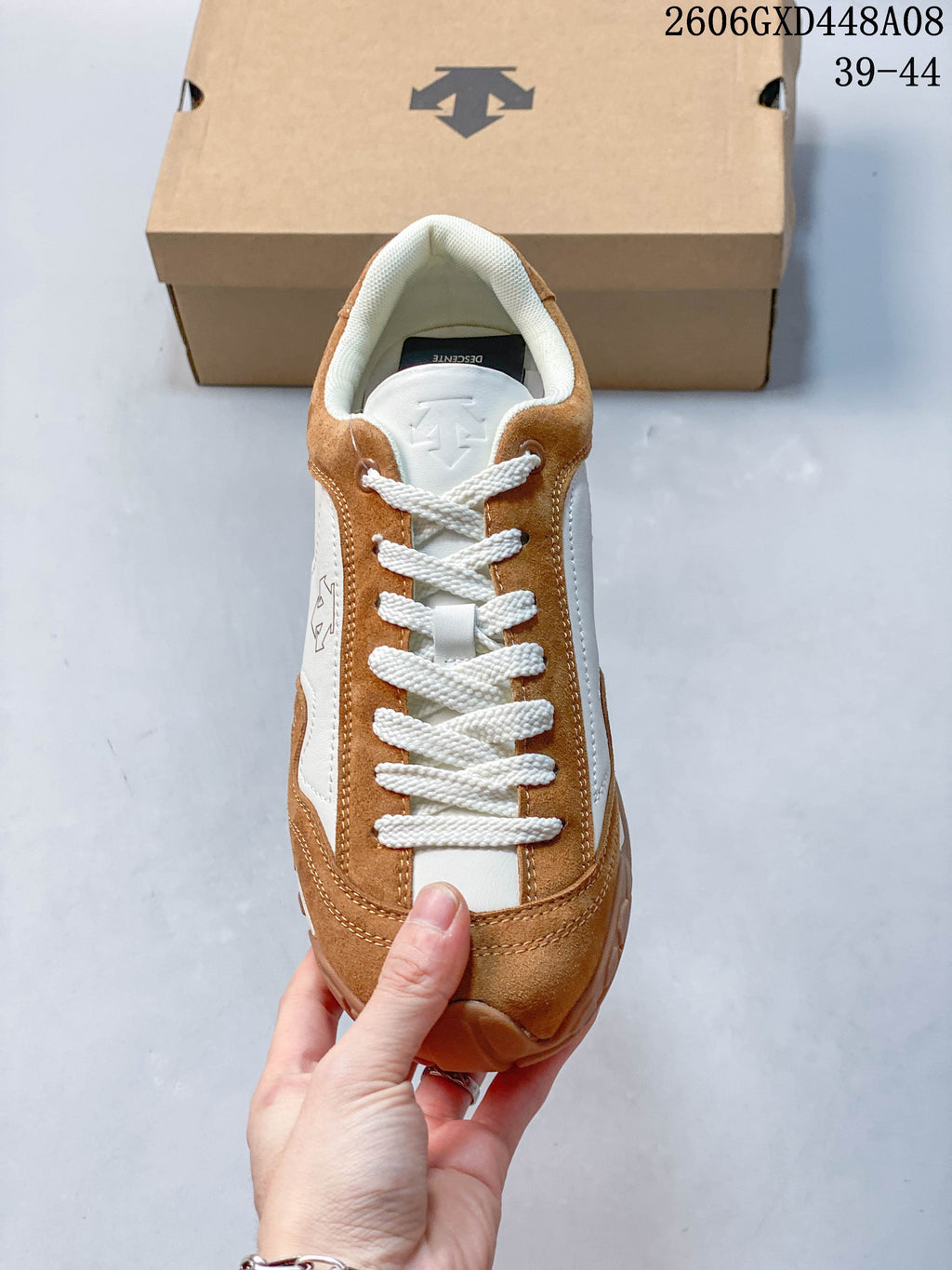 Top view showing the white laces and layered brown and white upper