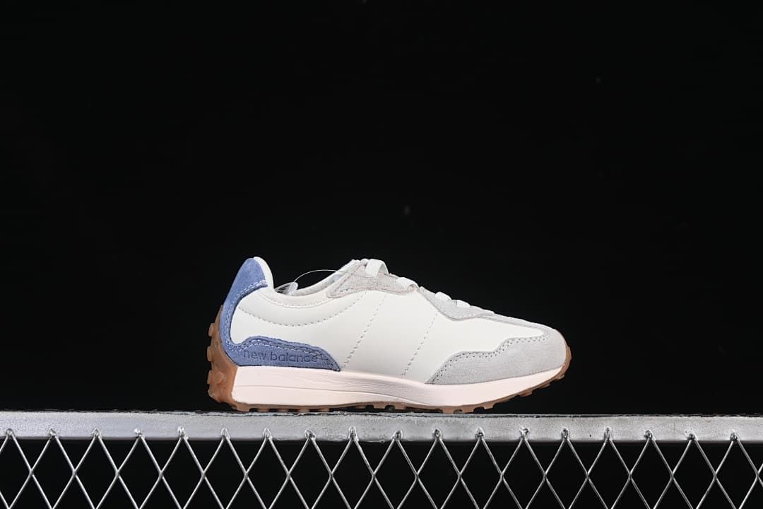 Side profile showing the white upper, grey toe overlay, blue heel panel, and gum outsole.