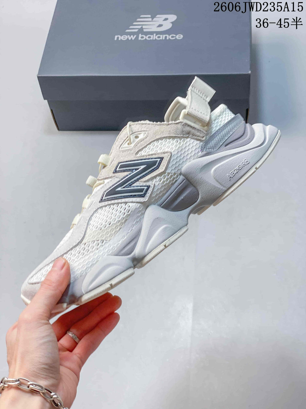 Side view of a New Balance 9060 sneaker with mesh panels and layered sole