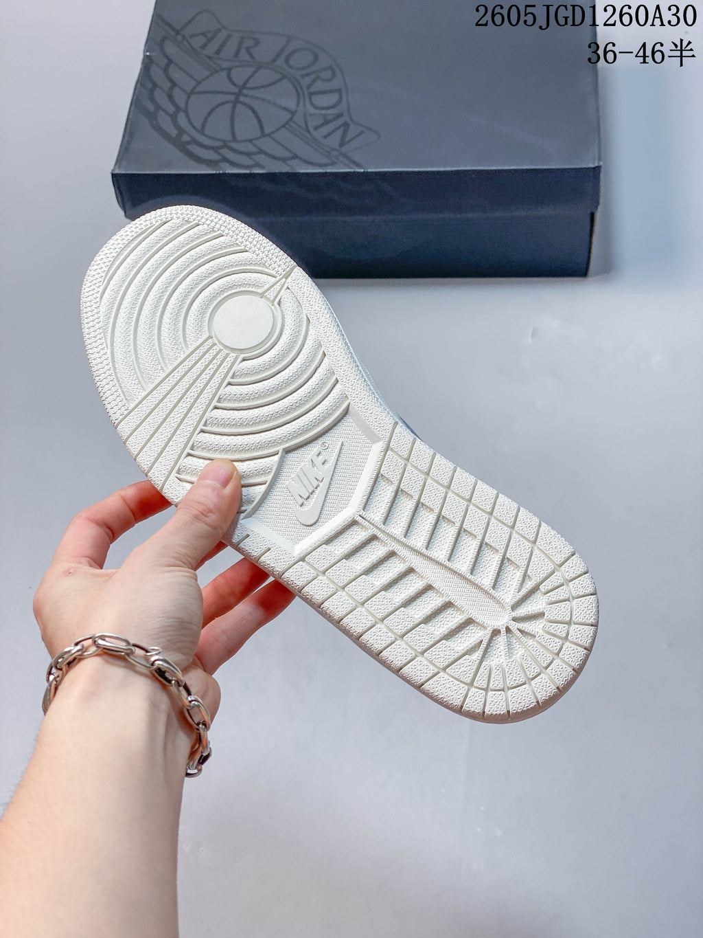 Close-up of the white patterned outsole on an Air Jordan 1 Low sneaker