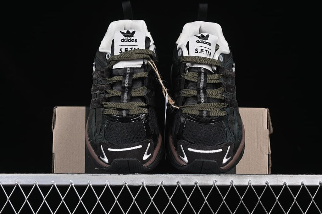 Front view of the pair showing the dark uppers, olive-toned laces and contrasting toe details.