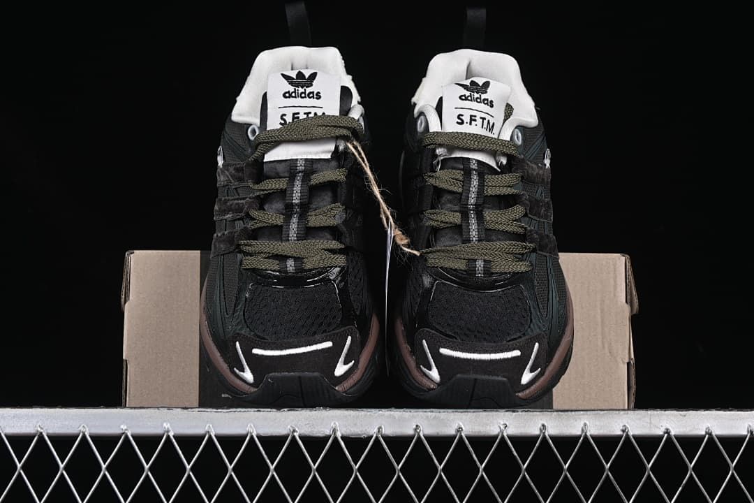 Front view of the pair showing the dark uppers, olive-toned laces and contrasting toe details.