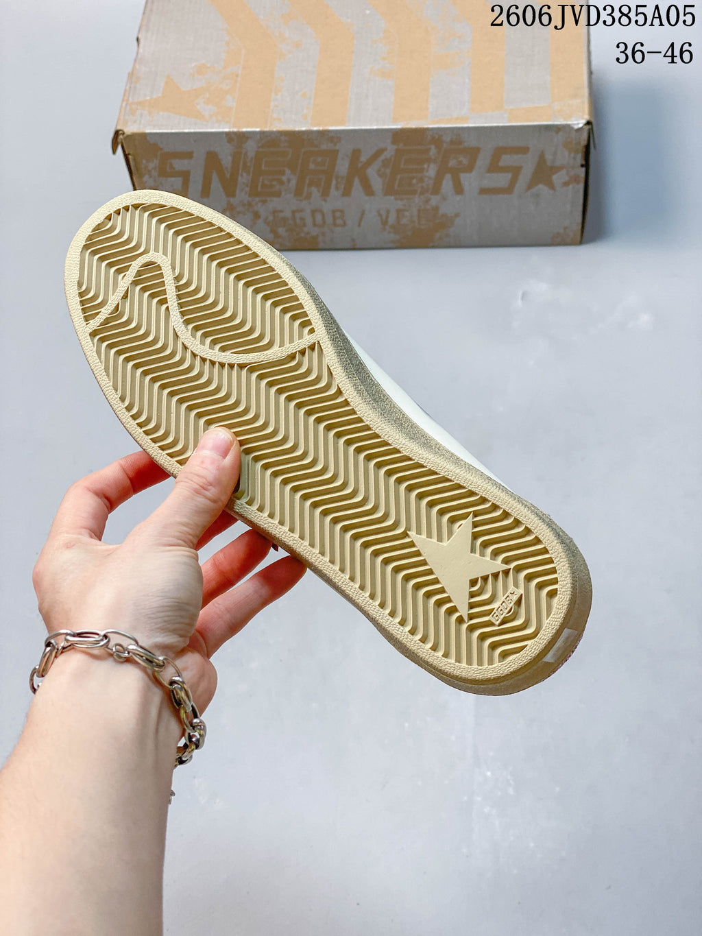 View of the sneaker's beige-toned patterned outsole.