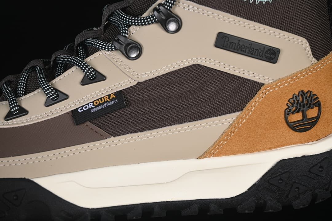 Close-up of the boot's lace hooks, contrast panels, and visible branding