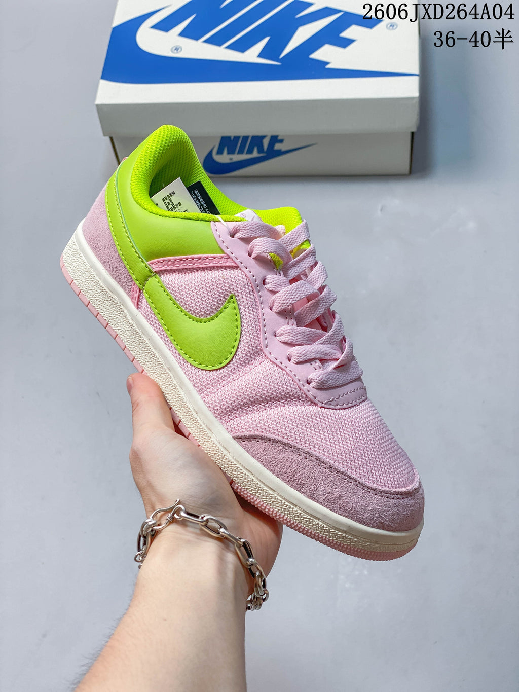 Pink low-top sneaker with bright lime accents and a light-colored sole