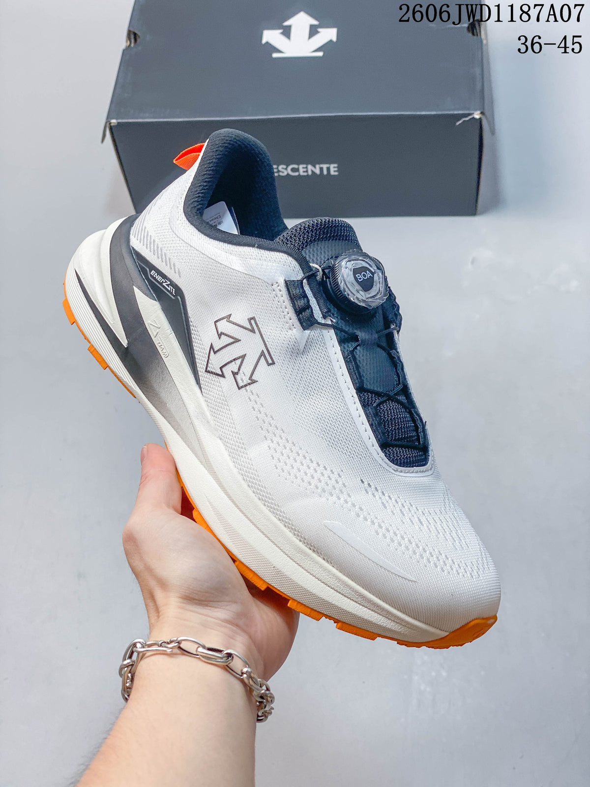 Angled side view of the shoe showing the DESCENTE logo, dial closure, and orange outsole