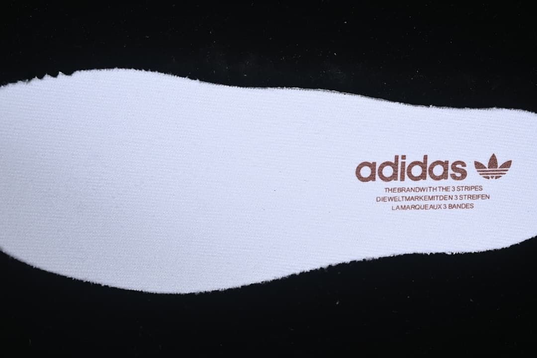 Insole with adidas branding and three-stripe text