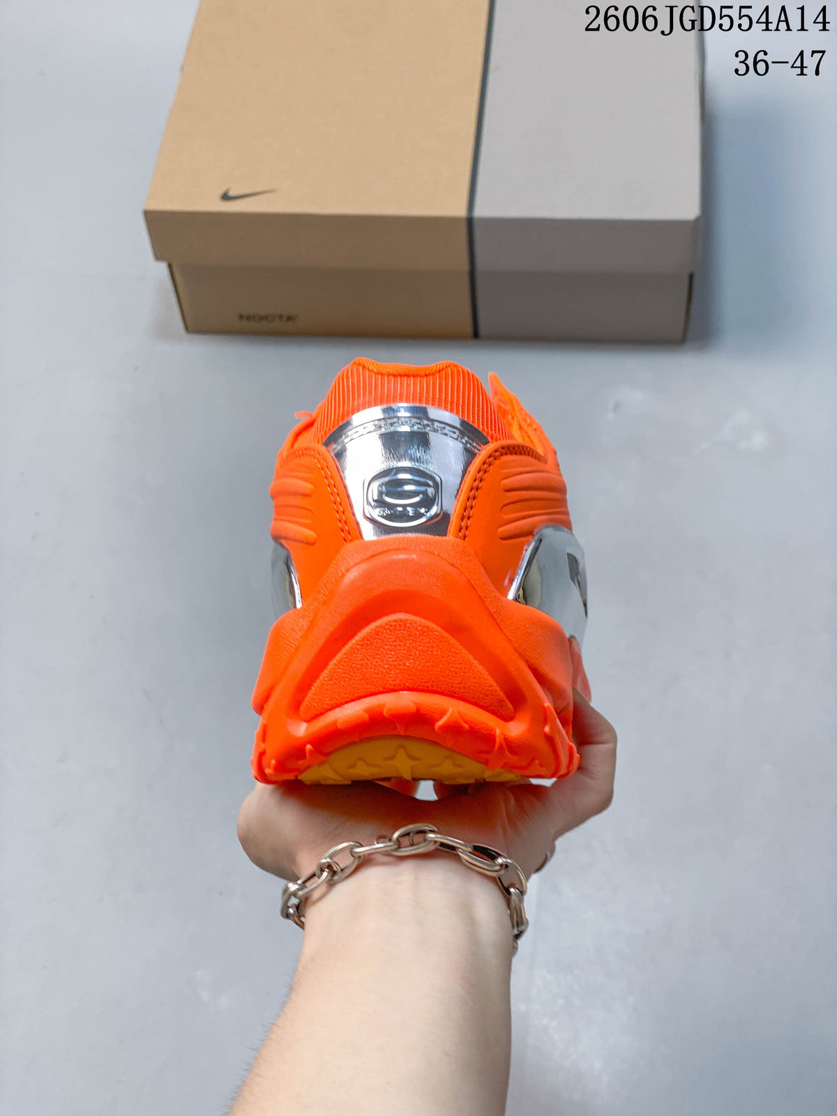 Rear view of the orange sneaker with reflective silver heel detail