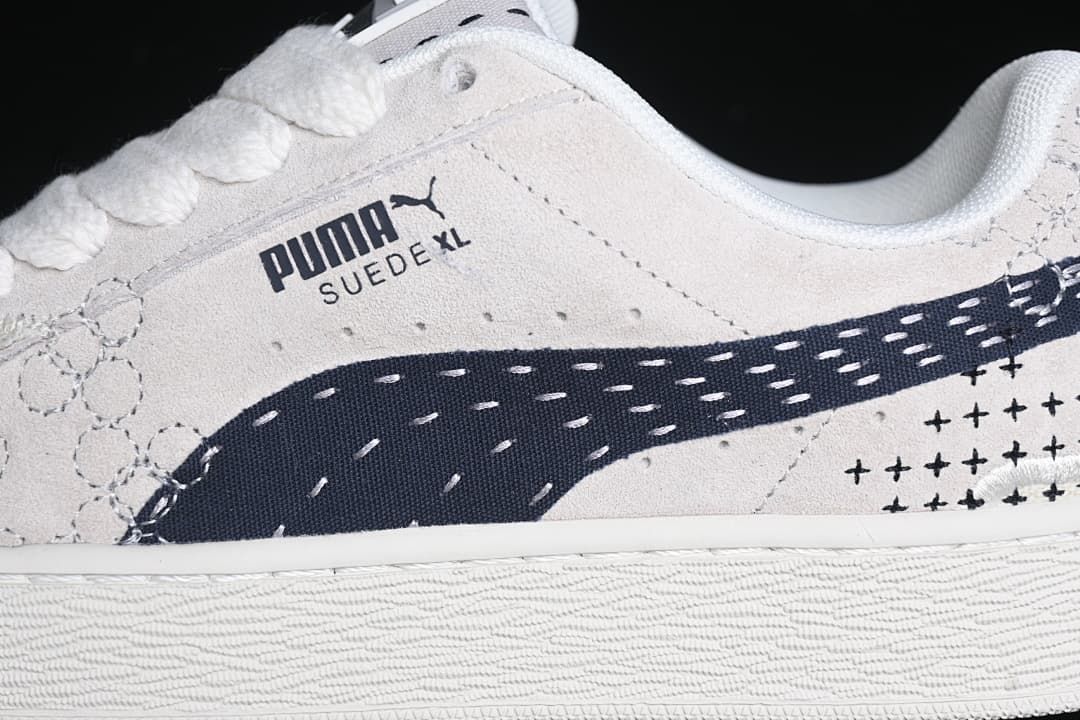 Close-up of the Puma Suede XL side branding and navy side detail.