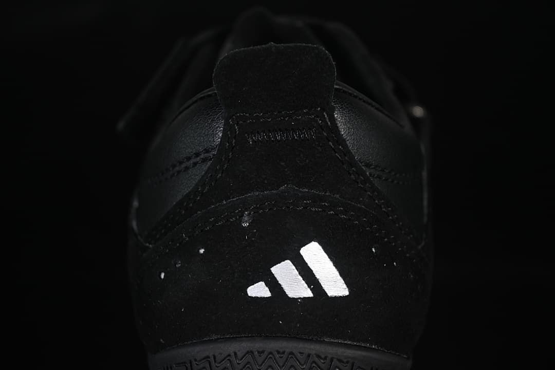 Rear view of the black sneaker with a white logo mark