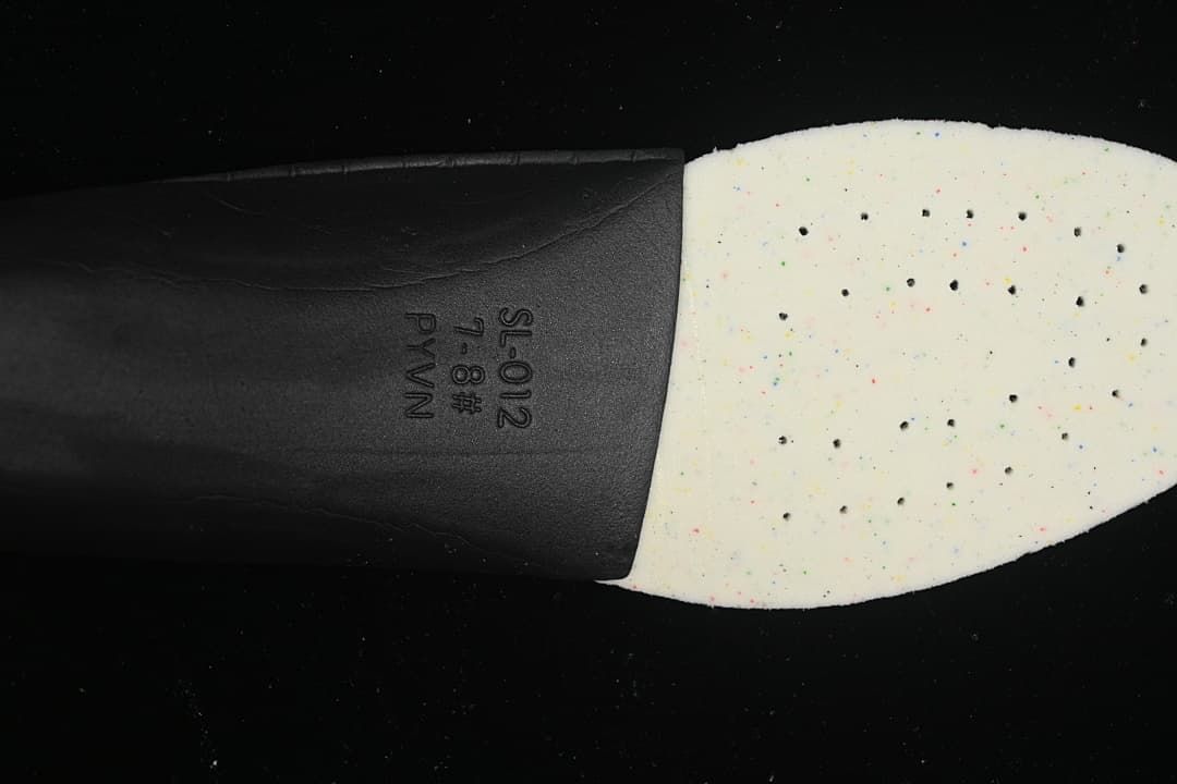 Close-up of a shoe insole showing a speckled forefoot section.