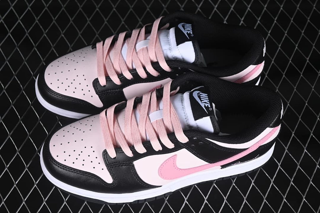 Pair of black, pale pink, and white low-top sneakers viewed from above