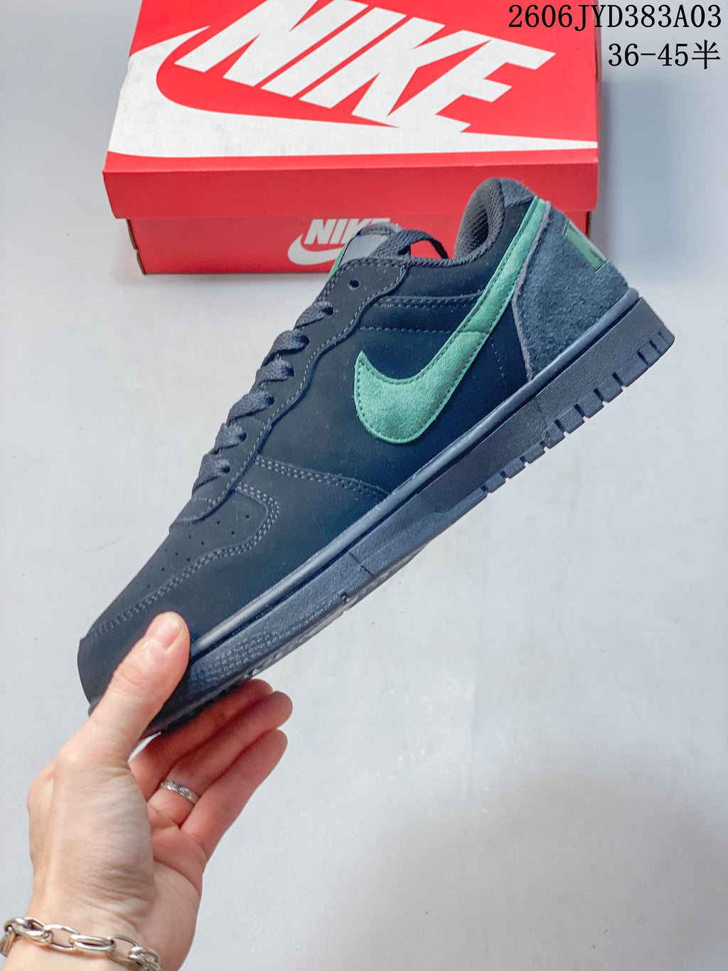 Side profile of the navy low-top sneaker with a mint-green Swoosh