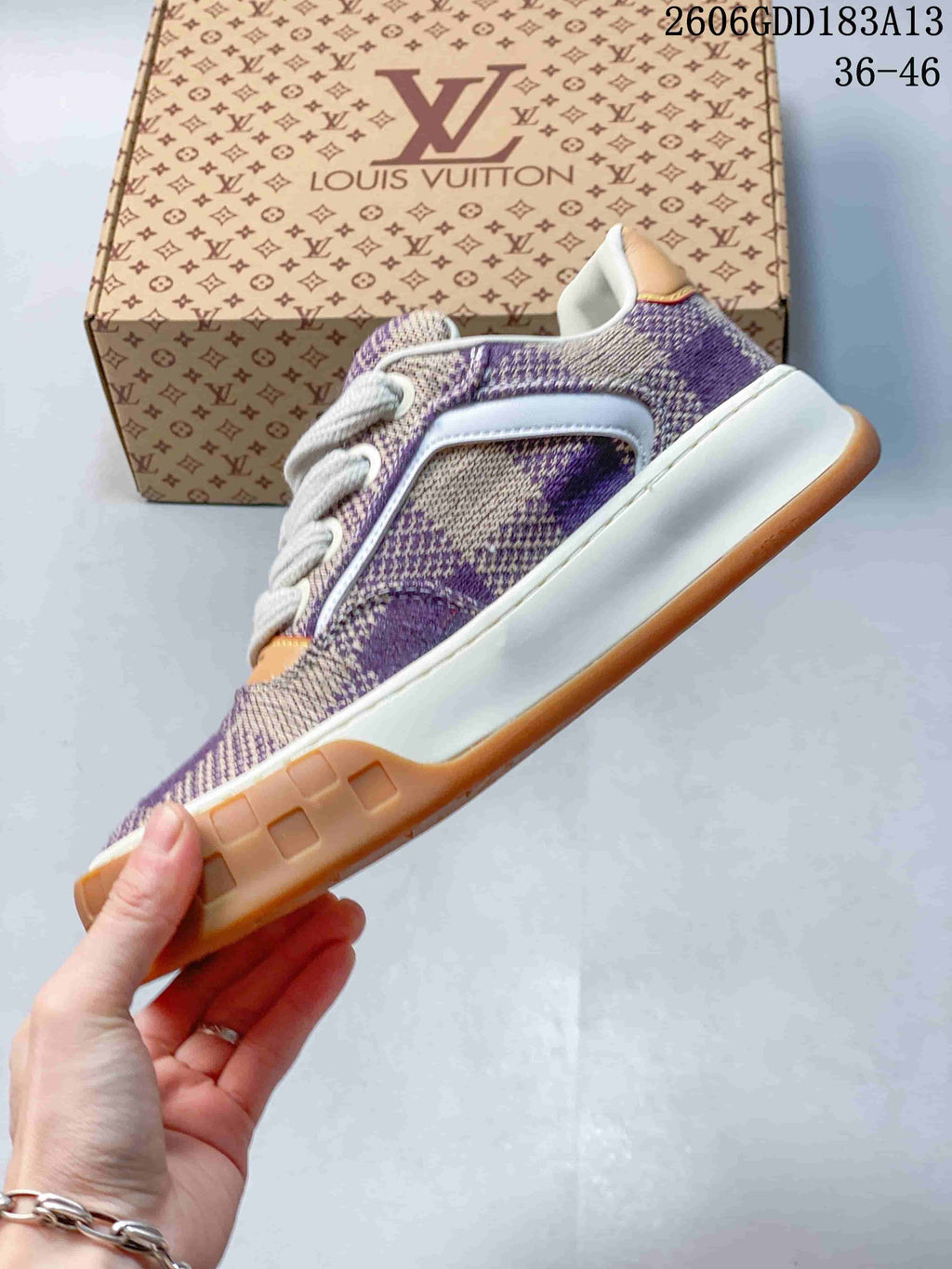 Side view of the purple and beige check-patterned low-top sneaker with white midsole and tan tread