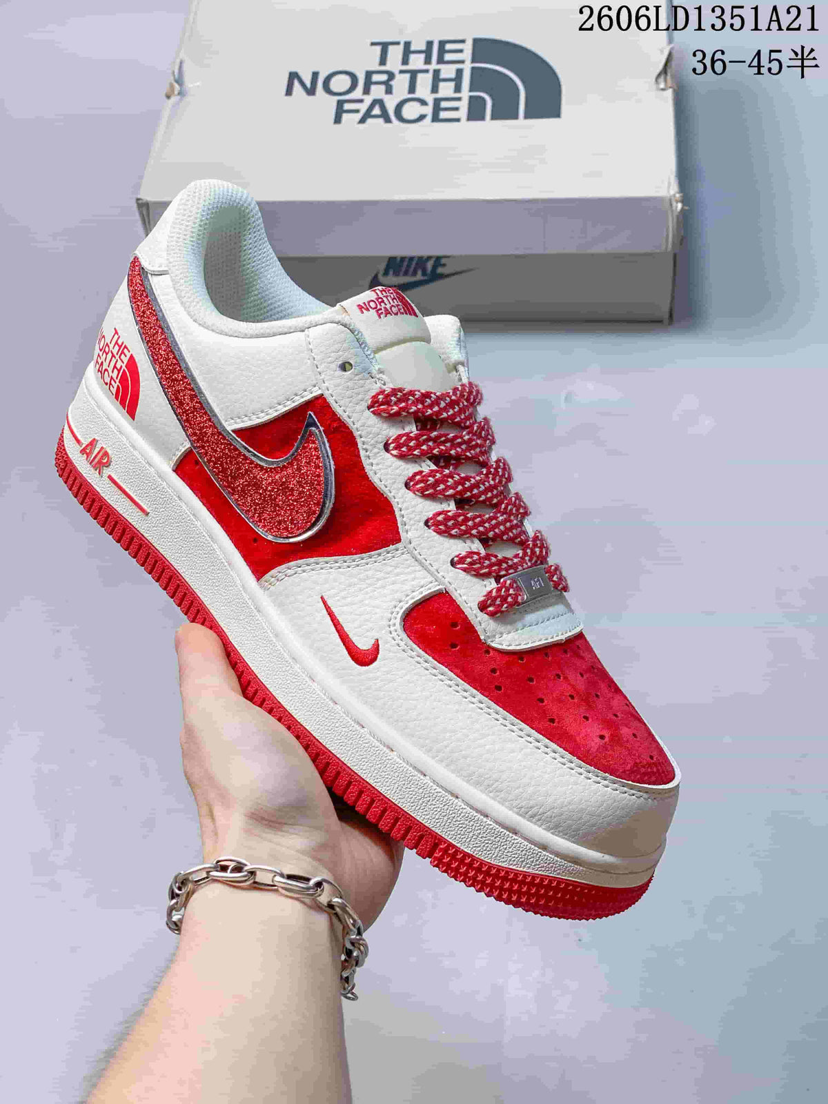 White low-top sneaker with red glitter Swoosh and red accents