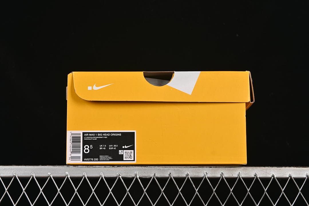 Yellow Nike shoe box with a product label identifying Air Max 1 Big Head Origins, style HV5776 200, and EU 42.