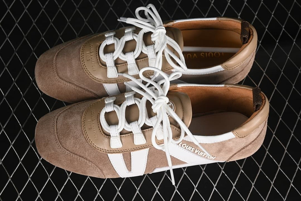 Pair of beige and white low-profile sneakers shown from above