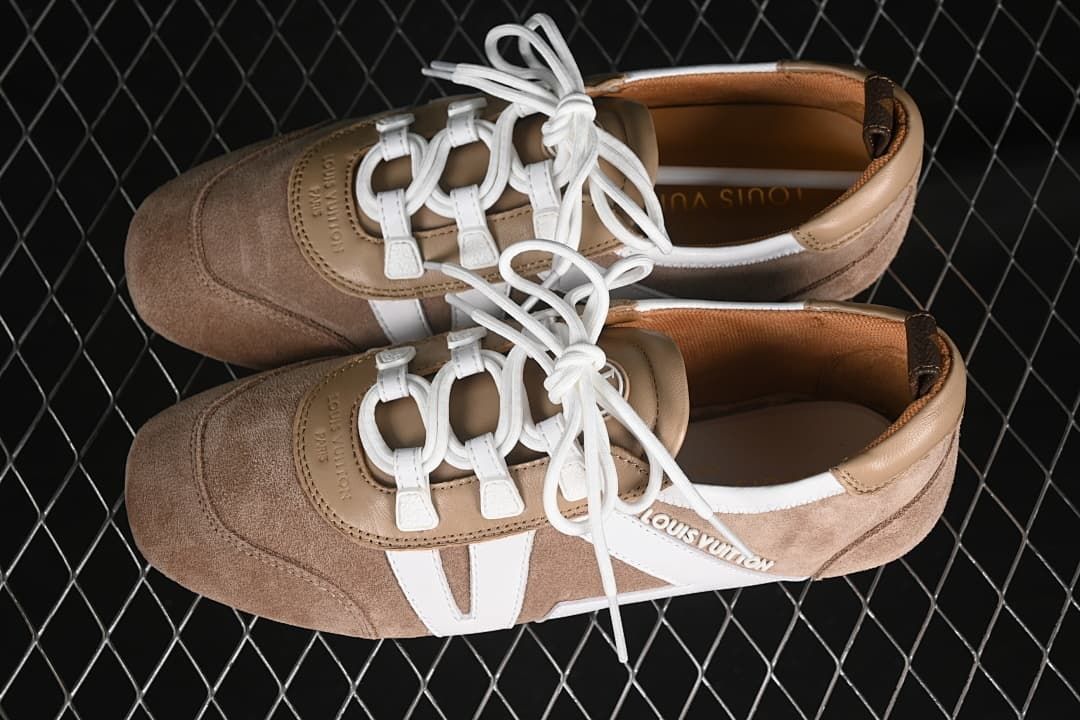 Pair of beige and white low-profile sneakers shown from above