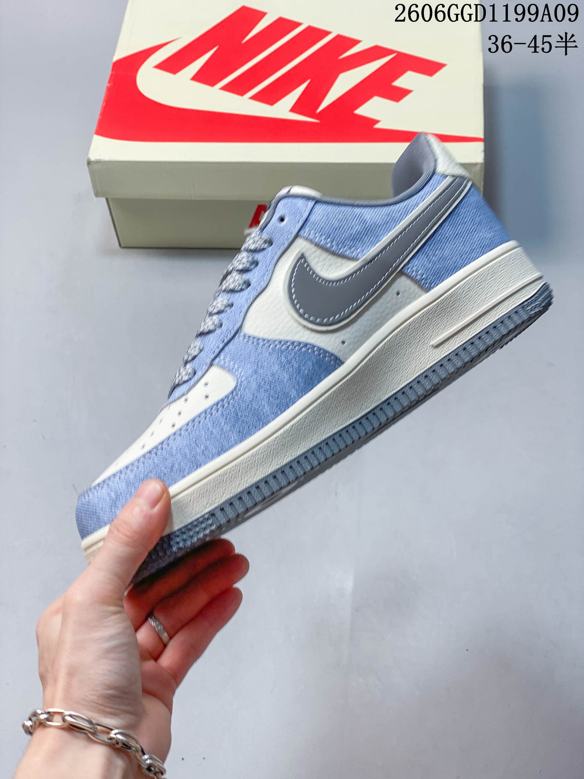 Side view of a blue and off-white low-top sneaker with a gray Swoosh.