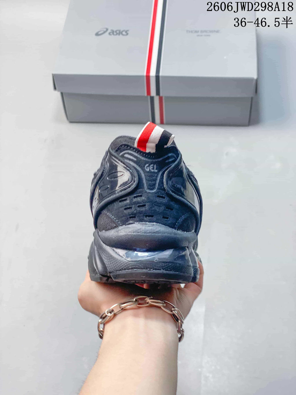 Rear view of the sneaker showing GEL lettering and a striped heel pull tab