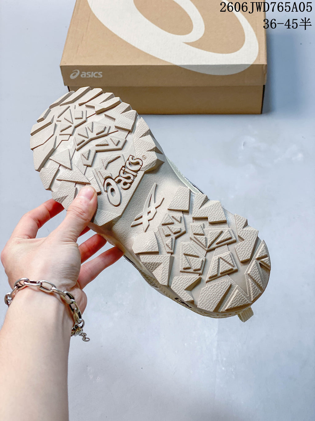 Close-up of the textured outsole on a cream ASICS Gel-TRUCK sneaker