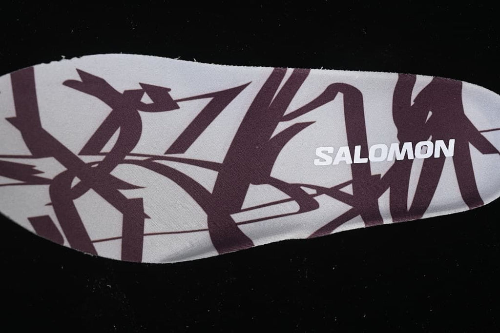 Close-up of a patterned insole bearing the Salomon name.
