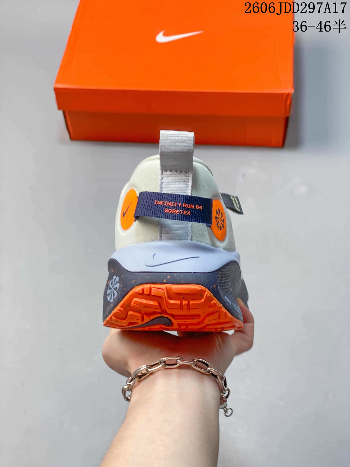 Rear view of a Nike InfinityRN 4 shoe showing its heel details and orange outsole.