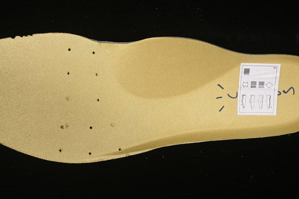 Close-up of a wheat-colored insole with a small printed graphic.