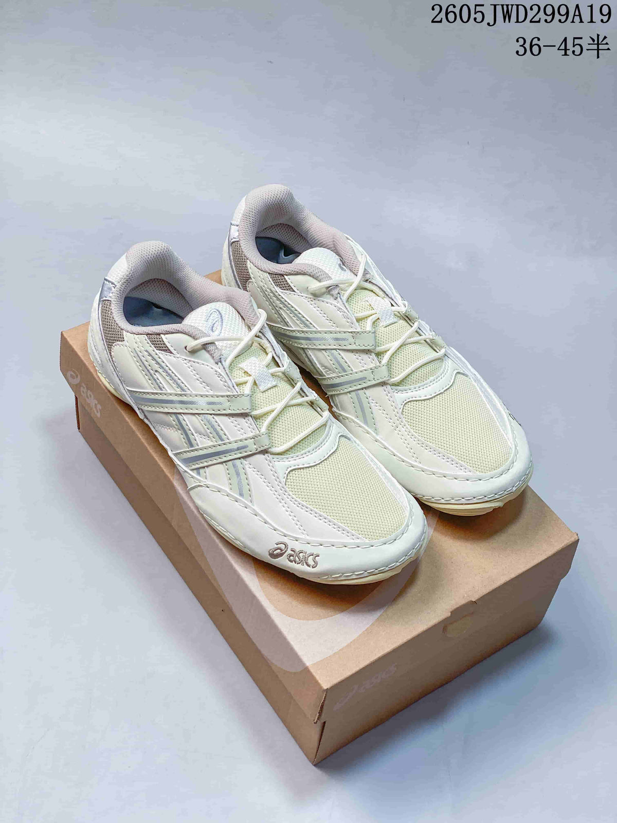 Pair of light cream ASICS GEL-1130 sneakers displayed on a shoebox