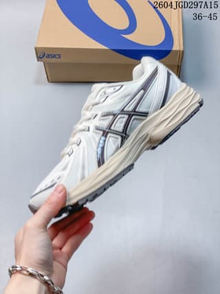 Side view of the white ASICS Gel-Flux CN shoe showing the mesh-textured upper, dark detailing, and sculpted midsole.