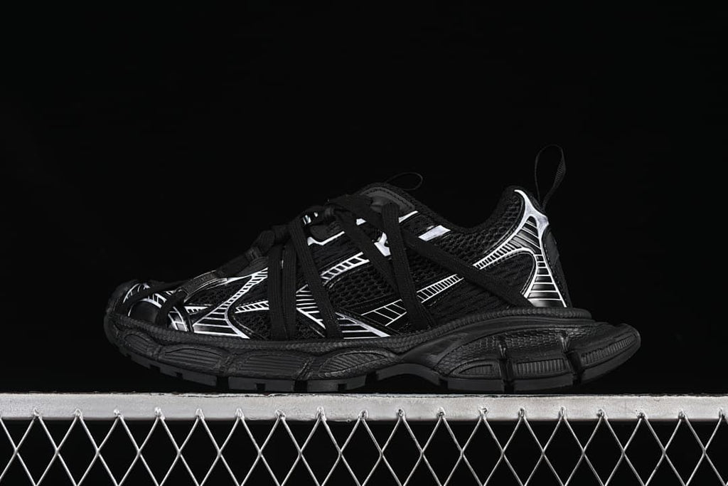 Black and white sneaker shown from the side against a dark background.
