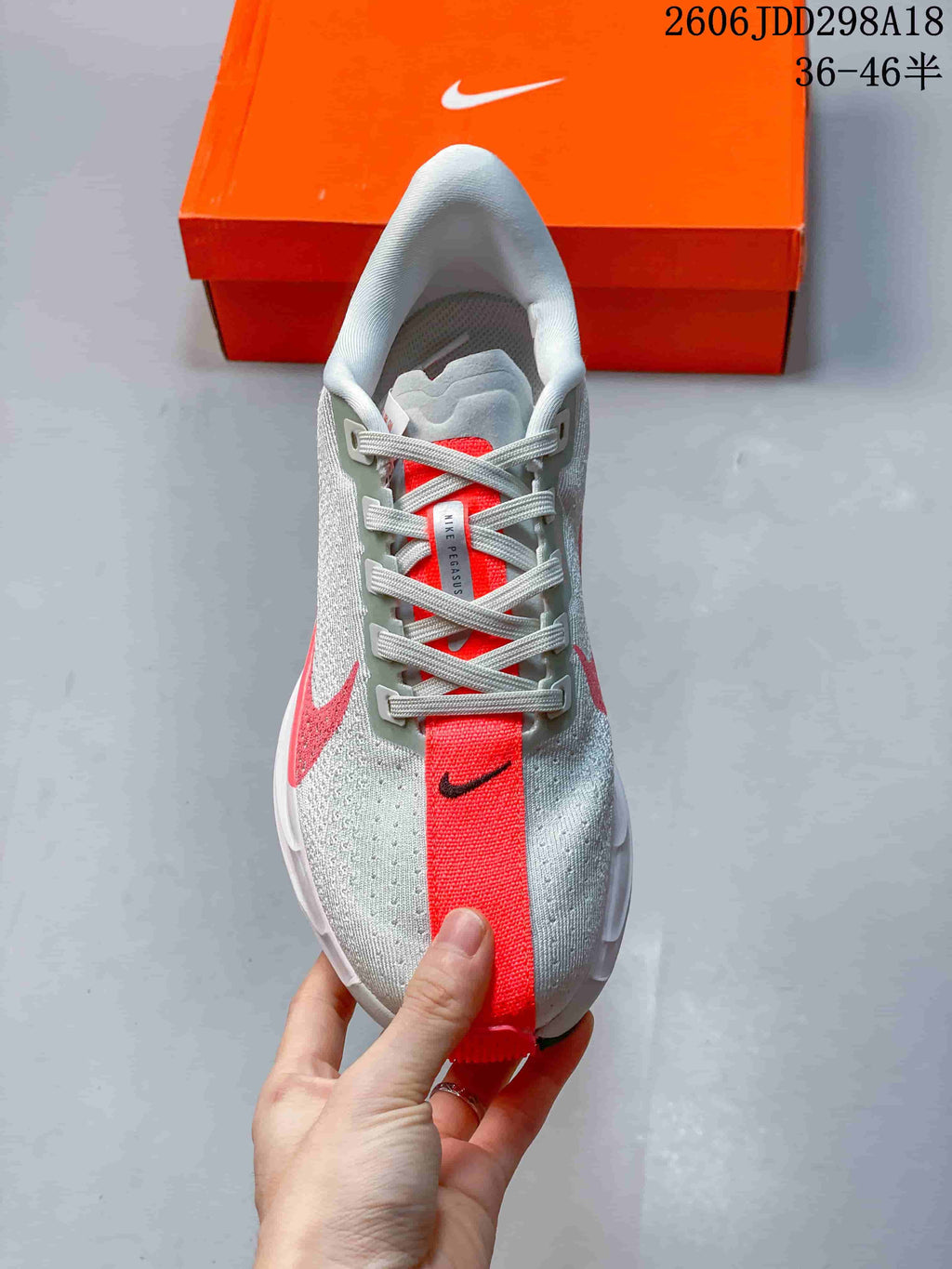 Top view of the lace-up shoe with a bright coral center stripe